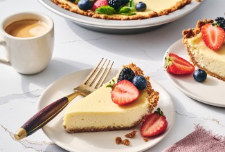 Easy Cheesecake sliced and on a plate with a cup of coffee