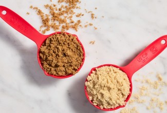 Dry measuring cups full of light and dark brown sugar