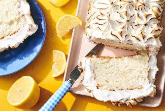 Lemon Angel Food Cake with Meringue Topping sliced on a serving tray