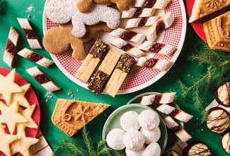 Variety of holiday cookies on a dark green background