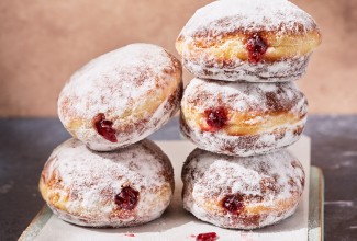 Two stacks of Pączki (Polish Doughnuts)