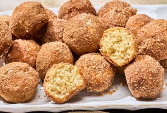 A group of Maple French Toast Mini Muffins with some broken in half to show the interior crumb.
