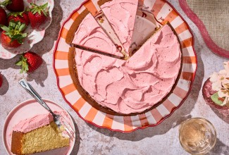 Brown Sugar Strawberry Frosted Cake sliced on a striped plate
