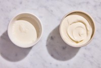 A bowl of leftover heavy cream next to a bowl of creme fraiche