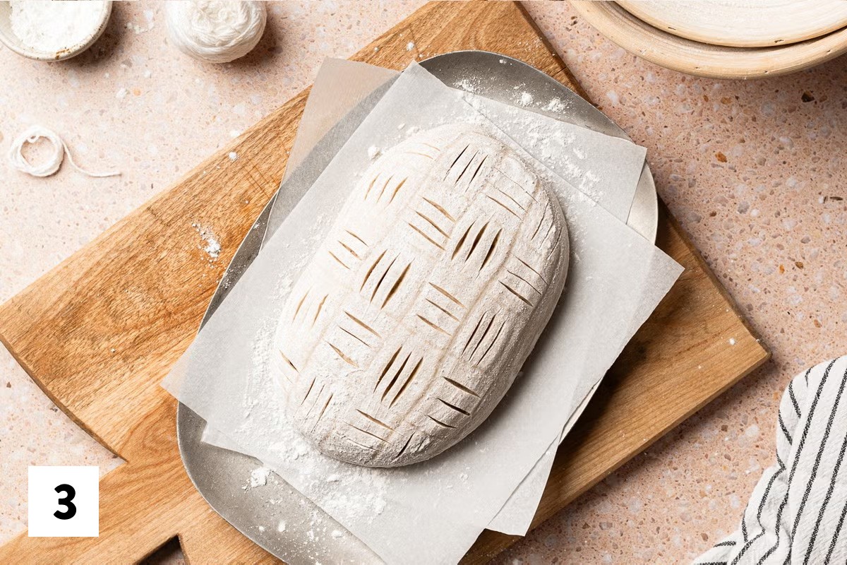 Sourdough loaf with a basket weave design scored into it