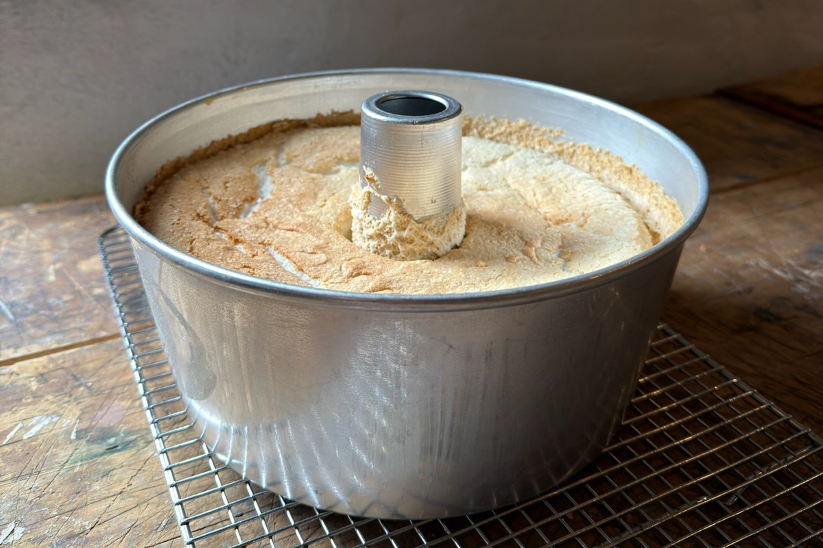 Angel food cake cooled right-side up, still in its pan 