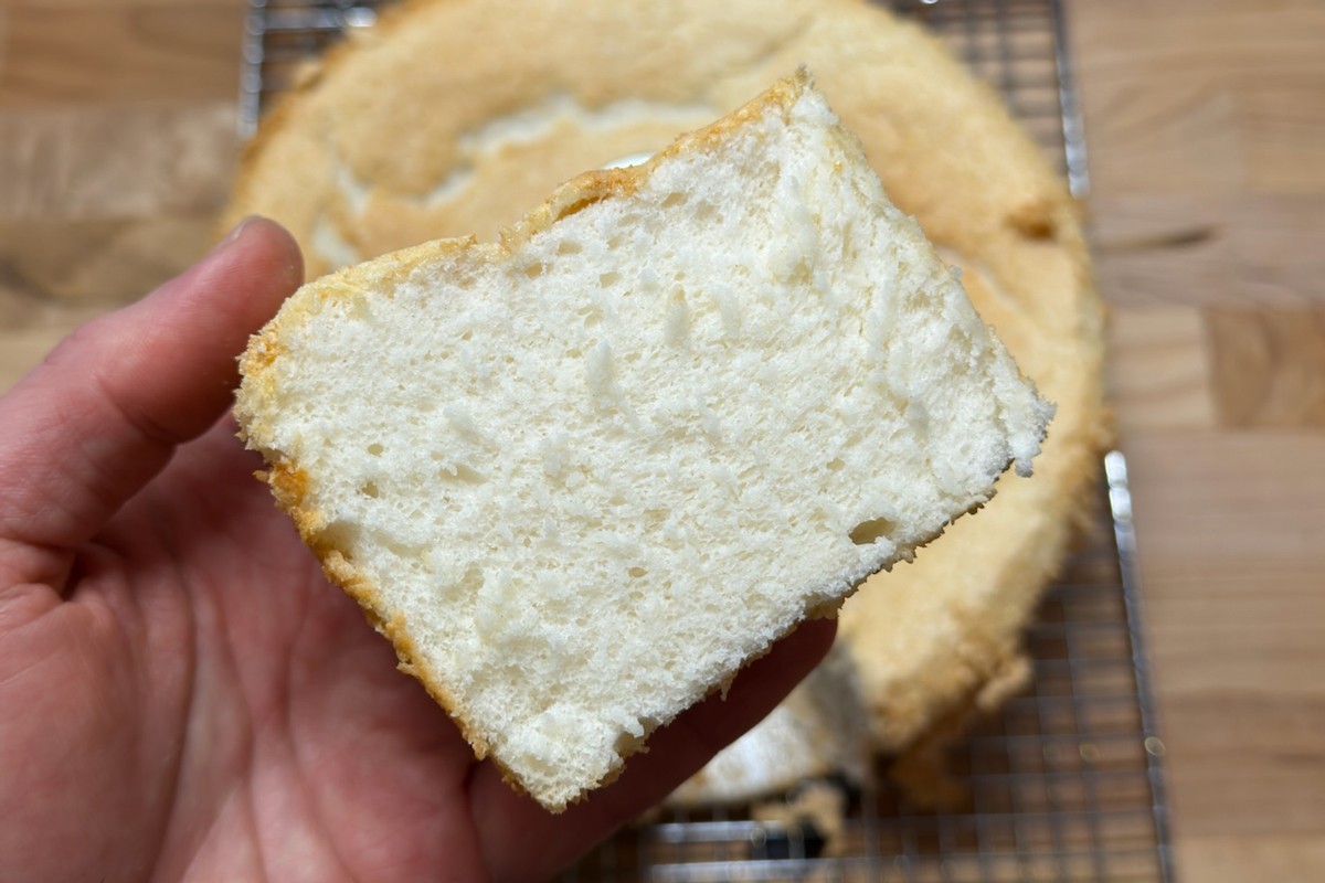 Slice of angel food cake, slightly compressed, after being cooled right-side up