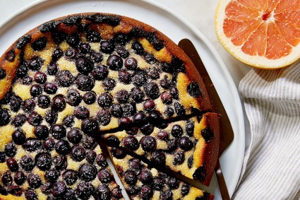 A Blueberry Breakfast Cake cut into slices on a platter, ready to be served.