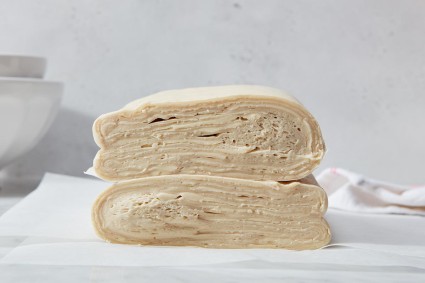 A cross-section showing laminated dough with fewer folds and more distinct layers