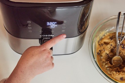 Pressing start on air fryer