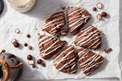 Chocolate malted scones drizzles with glaze and surrounded by malted milk balls