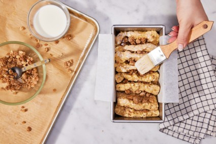 Brushing scone loaf with cream before baking