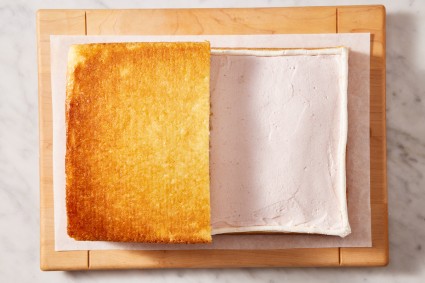 Sheet cake layer cake, with one half of top layer of cake placed over filling