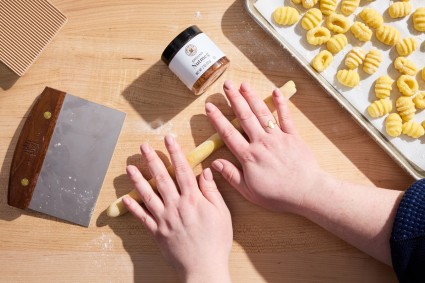 Rolling gnocchi dough to shape gnocchi 
