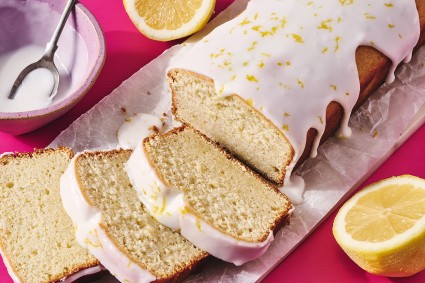 Glazed Sourdough Lemon Cake sliced up on parchment paper