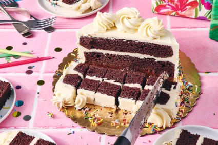 Cutting a round birthday cake into small strips