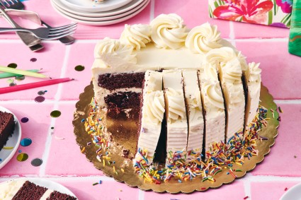 Round birthday cake cut into strips instead of slices