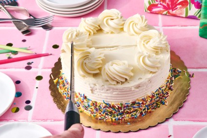 Round cake being cut into strips