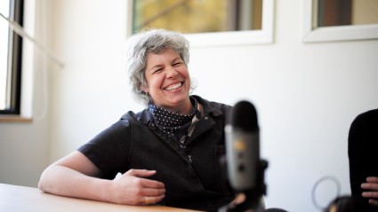 Jessica Battilana behind her podcast microphone.