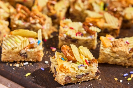 Cut-up pieces of Kitchen Sink Cookie Bars on a counter