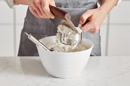 Measuring flour with a dry measuring cup