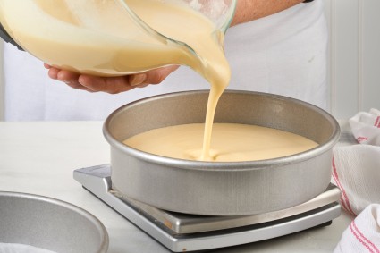 Pouring cake batter into a cake pan