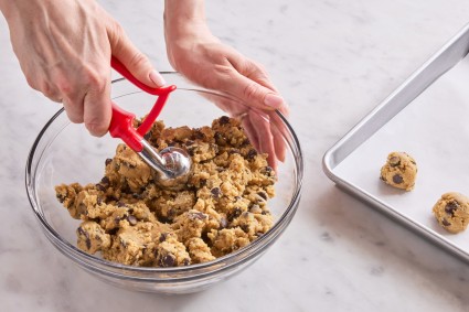 Scooping cookie dough with tablespoon scoop