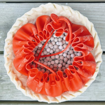 Orange silicone pie pouch filled with ceramic pie weights