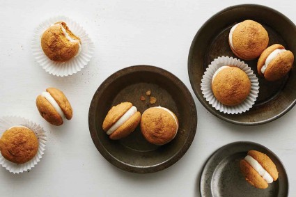 Pumpkin Whoopie Pies on serving plates in cupcake papers