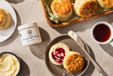 Sourdough Discard Buttermilk Biscuits on a plate with a cup of coffee