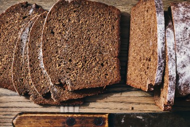 Classic Pumpernickel Bread sliced on a cutting board