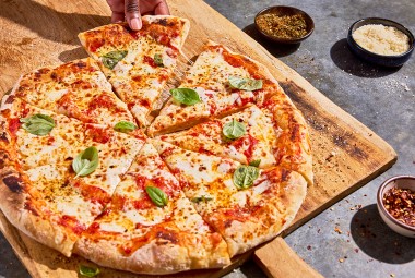 No-Knead Pizza Crust sliced on a cutting board