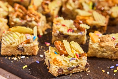 Cut-up pieces of Kitchen Sink Cookie Bars on a counter