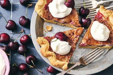 3 slices of Cherry-Vanilla Cream Pie in a pie dish topped with whipped cream