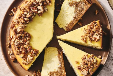 Carrot Cake Cheesecake with golden creamy cheesecake and edged with walnuts.