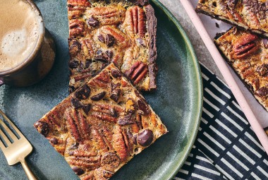 Two slices of Slab Chocolate Pecan Pie on a plate.