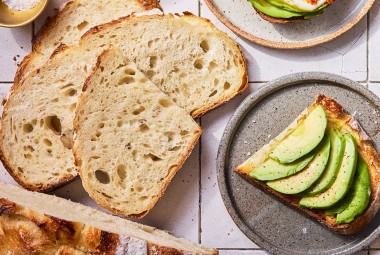 No-Knead Sourdough Bread on a cutting board with some avocado toast
