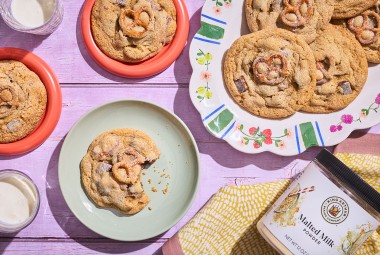 Malted Peanut Butter Chocolate Chip Cookies on plates arranged on a table, seen from above.